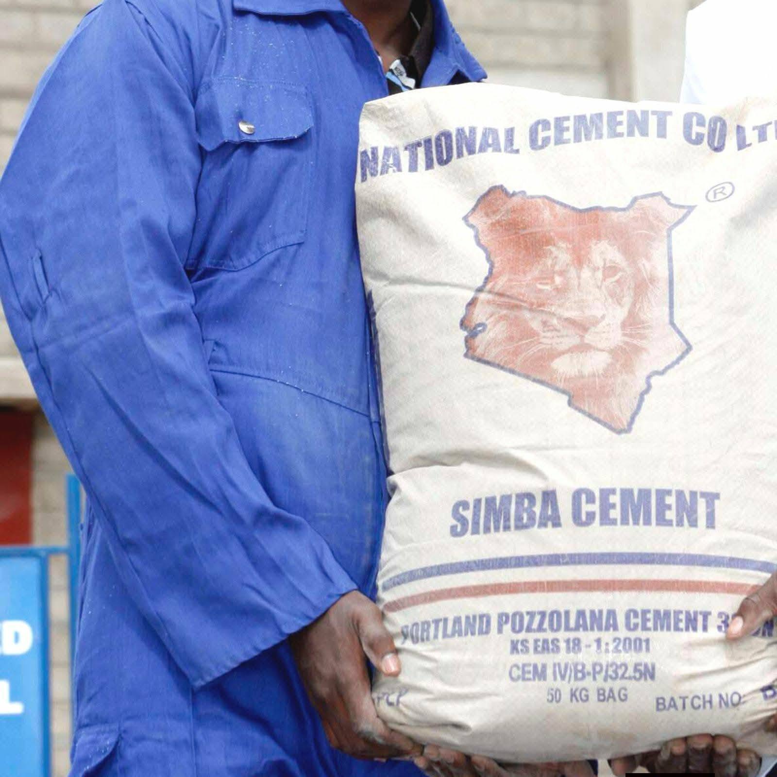 Worker carrying a 50kg Simba Cement bag